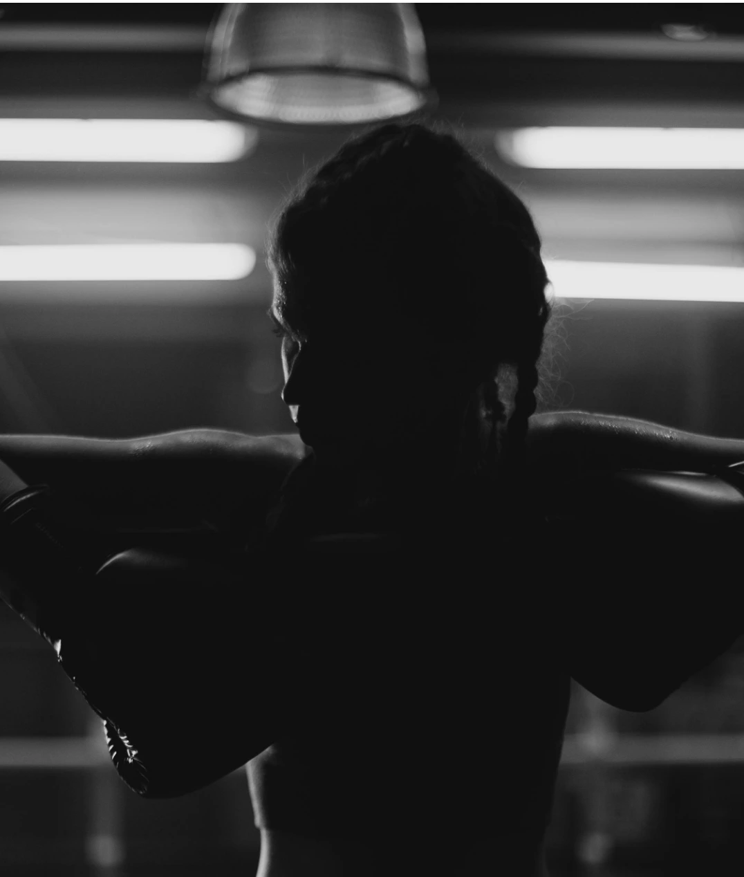 Resting silhouette of a woman in gloves, reflecting personal transformation through cancer coaching.